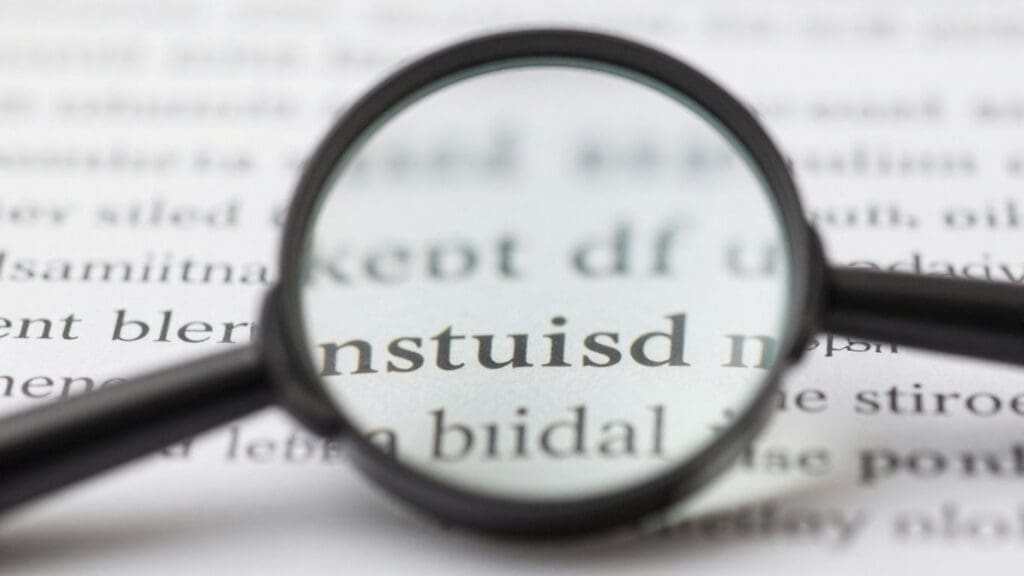 magnifying glass enlarging text on paper
