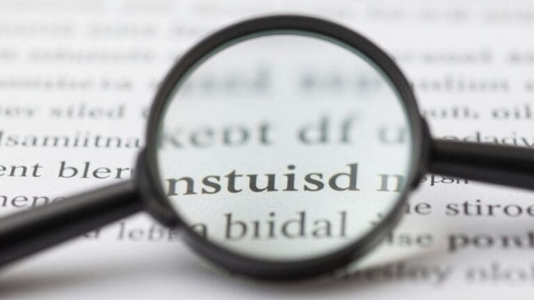 magnifying glass enlarging text on paper